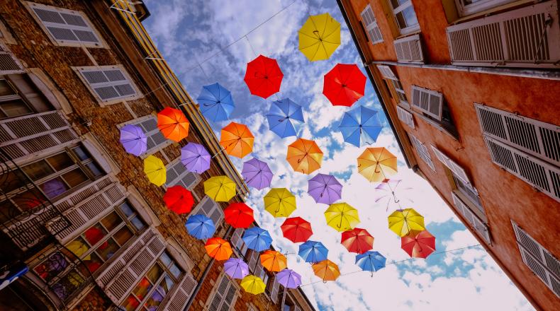 brightly colored umbrellas against the sky
