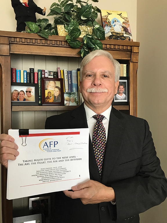 Dr. F. Duke Haddad holding an AFP certificate.