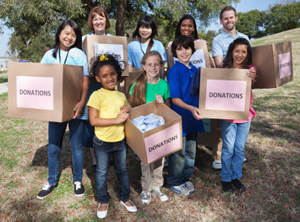 group of children holding donation boxes