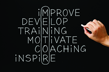 improve develop training motivate coaching inspire words on a chalkboard