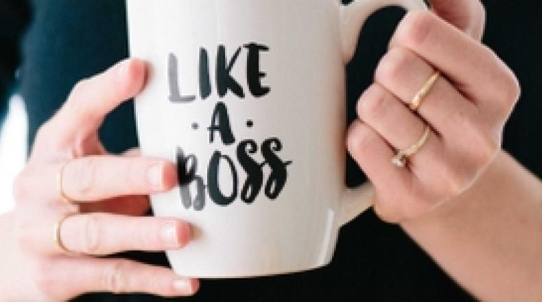 Woman holding a mug that says "Like a Boss"