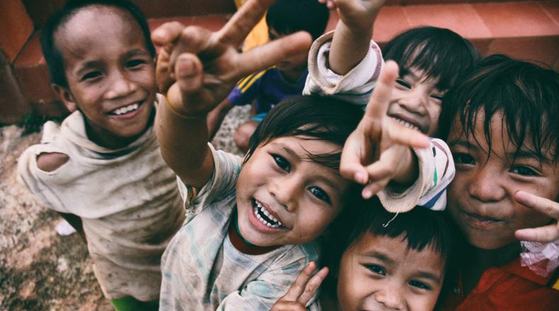 children smiling at person taking their picture