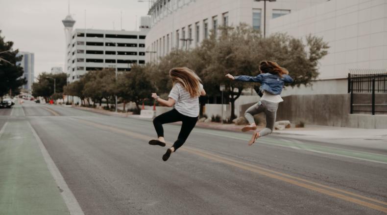 two people jumping happily