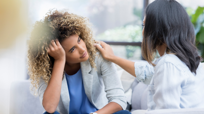 A woman comforts another woman