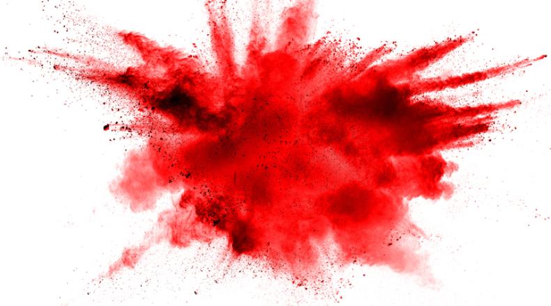 Abstract red dust splattered on white background. Red powder explosion on white background.
