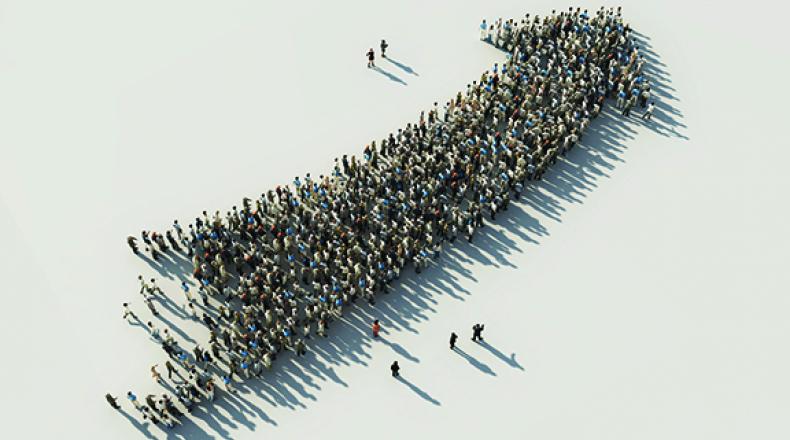 crowd of people forming the shape of an arrow