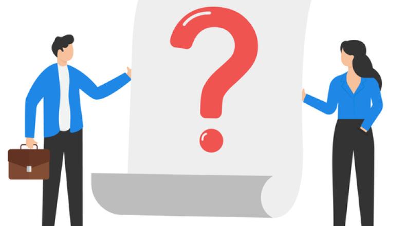 Business team stands near a large question mark