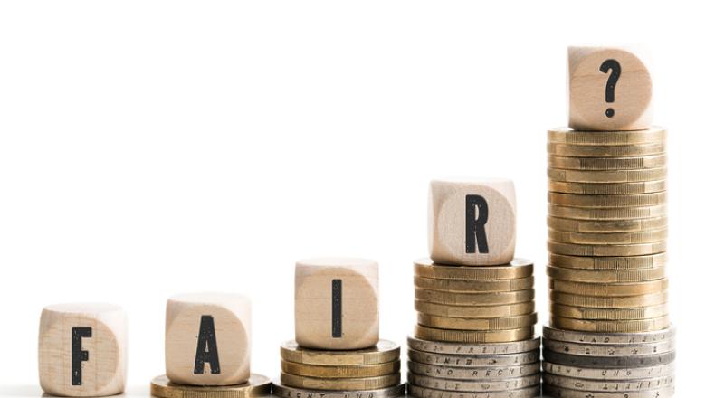 blocks spell word fair stacked on top of different amounts of coins
