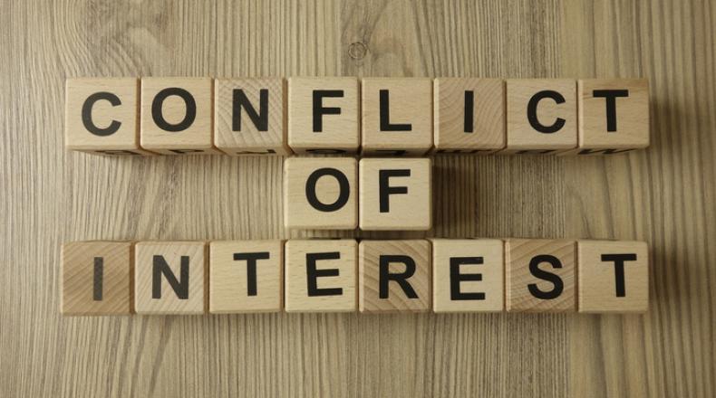Conflict of interest text from wooden blocks stock photo
