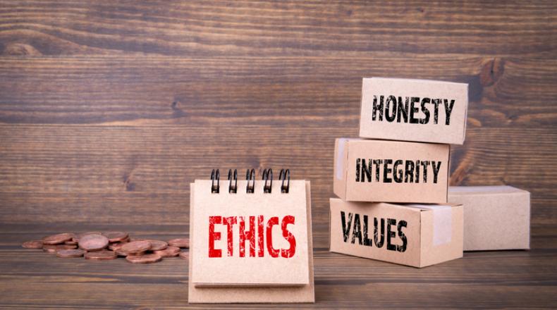 Ethics concept. Word ethics in red on brown background and words honesty, integrity and values words in black on stacked brown boxes