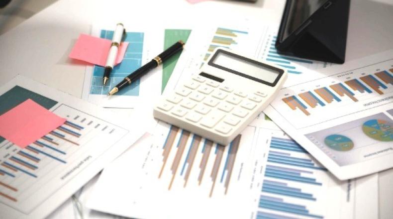 Desk with papers covered in graphs