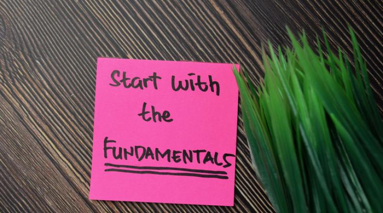 Start With The Fundamentals write on sticky notes isolated on office desk. stock photo