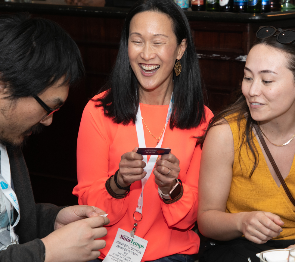 Group of AFP ICON attendees laughing and exchanging business cards