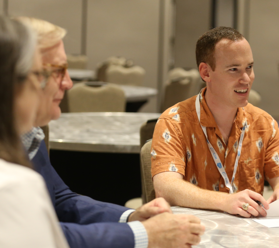 Man smiling at a table