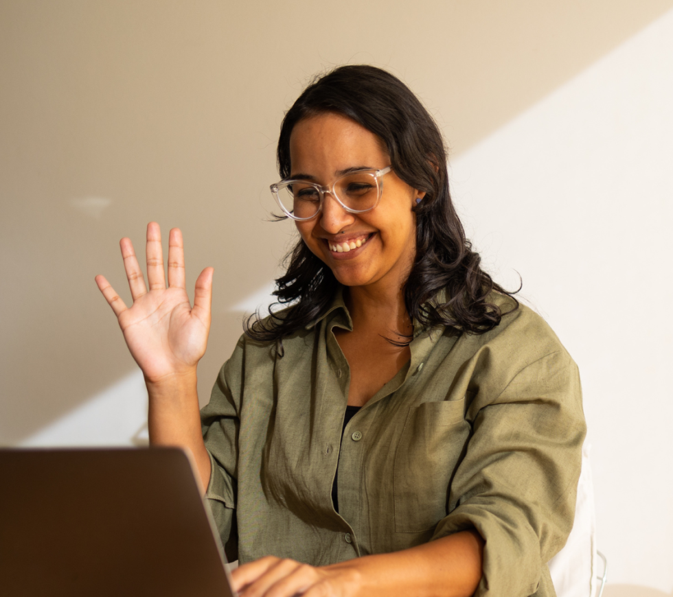 someone waving to a laptop