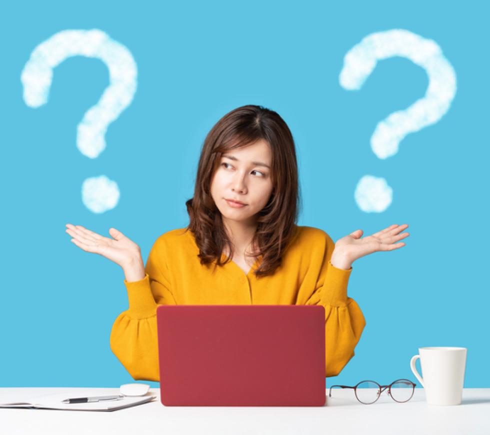 Young woman comparing with two things. stock photo