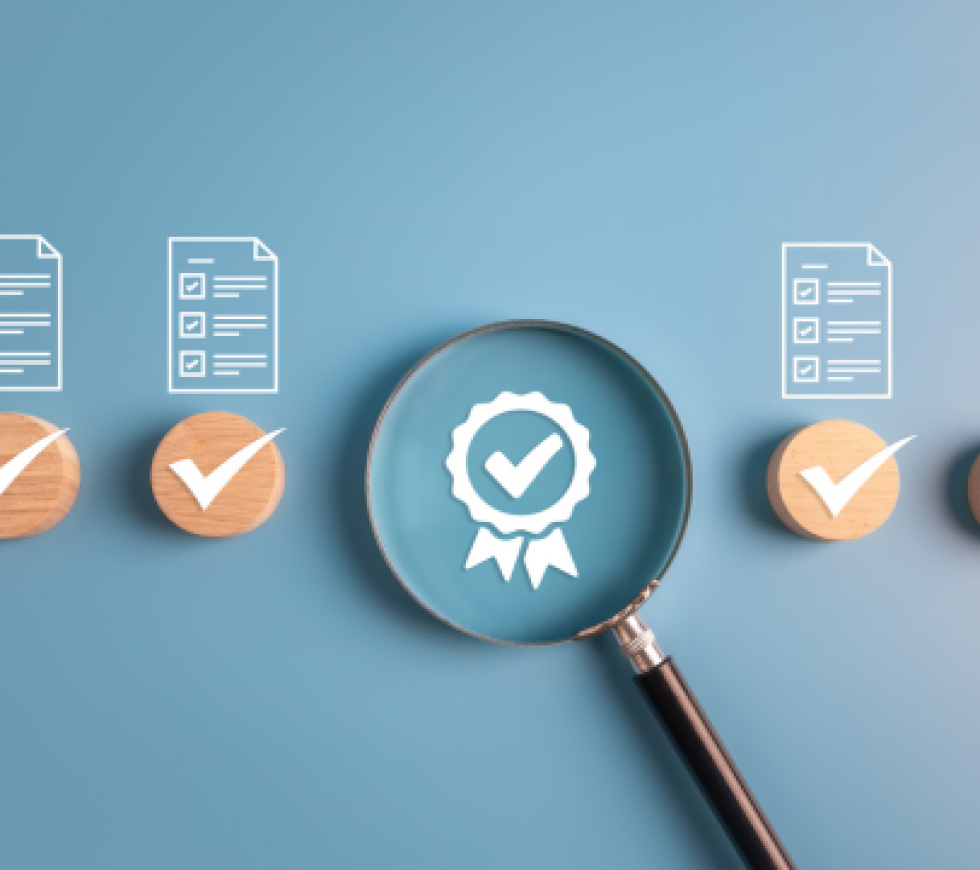 standards; magnifying glass over icon of a check mark on a ribbon