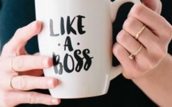 Woman holding a mug that says "Like a Boss"