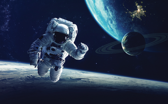 Astronaut in a spacesuit floating in space with planets and stars