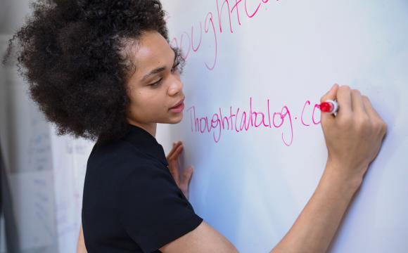 woman writing on whiteboard