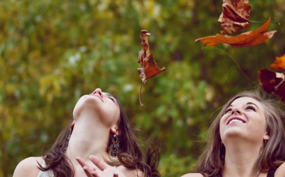 women throwing leaves