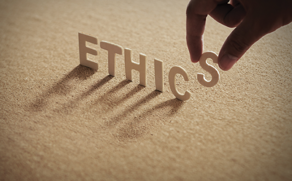 someone standing up letters that spell ethics