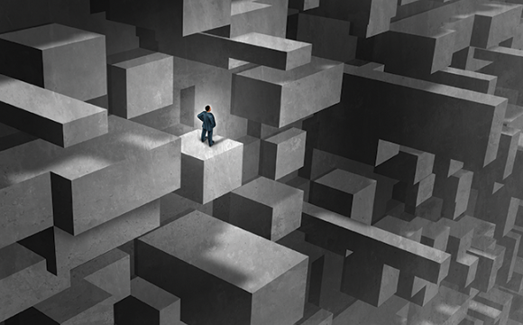 man standing in a maze of blocks