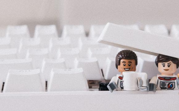 two lego people busting out of a keyboard