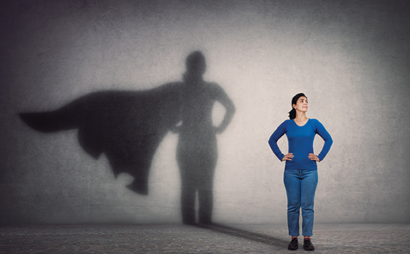 brave woman with her shadow showing a cape like a superhero
