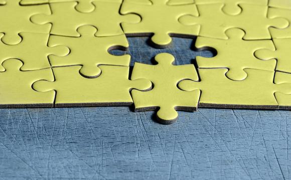 yellow jigsaw puzzle with one piece missing