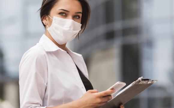 side view woman working during pandemic with smartphone notepad