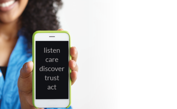 african american girl holding a phone that says listen care discover trust act