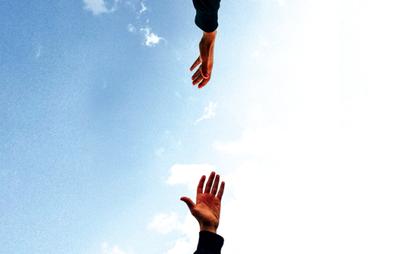 two hands reaching for each other