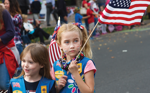 girl scouts with american flag