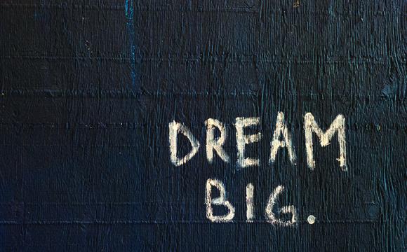 the words dream big on a black background