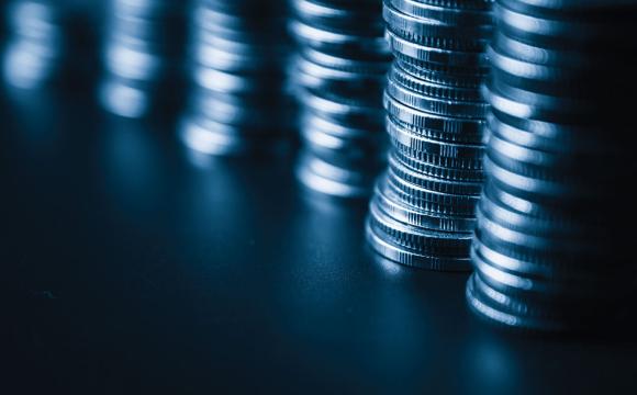 stacks of coins on a dark blue table
