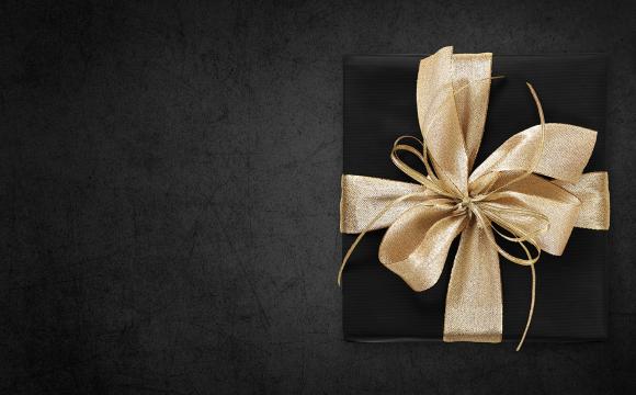 gold bow on a black wrapped gift