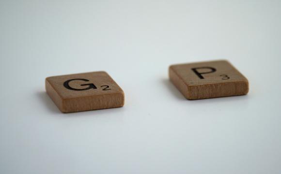 two small square wooden tiles space apart; one with letter G and one with letter P