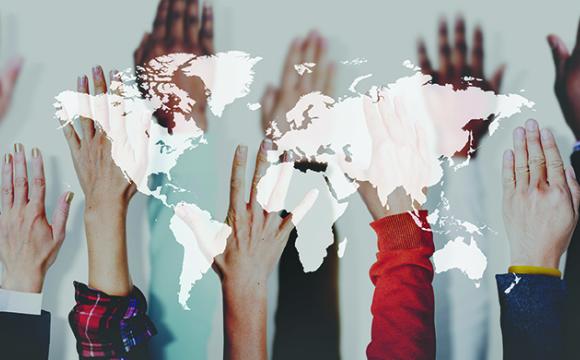 hands raised behind a map