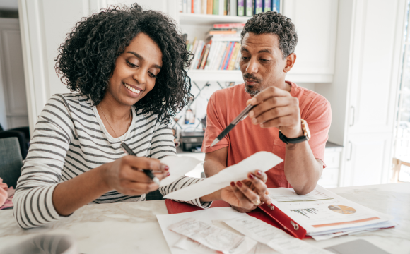 Two people looking at receipts