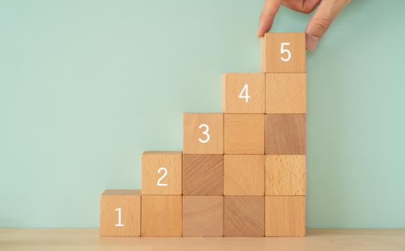 Step up; Wooden blocks with numbers and a hand