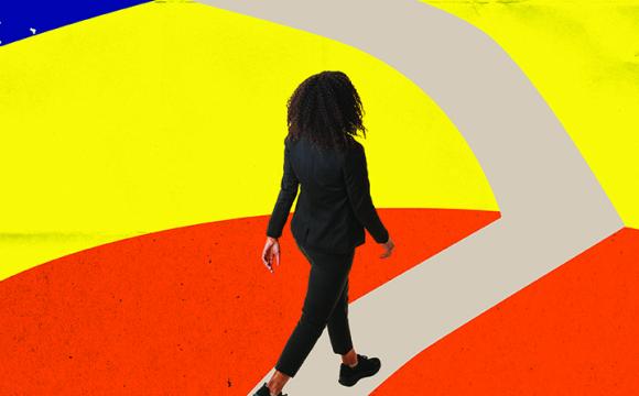 woman walking on a path with blue, yellow and orange in the background