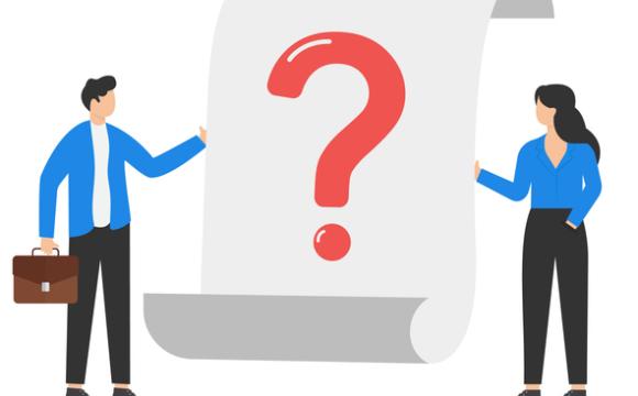 Business team stands near a large question mark