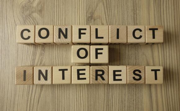 Conflict of interest text from wooden blocks stock photo
