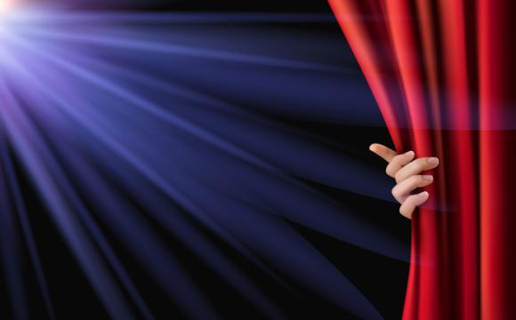 Background with red velvet curtain and hand.