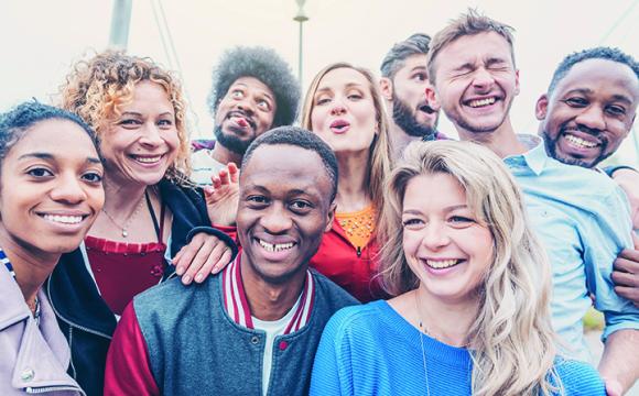 group of young men and women laughing
