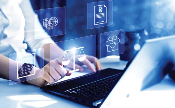 woman's hands on a keyboard of a laptop with overlapping icons on a blue background