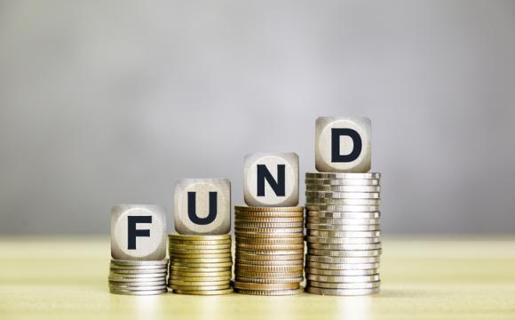 Stacks of coins topped with FUND blocks, symbolizing increasing investment funds, financial growth, and successful fund management. stock photo