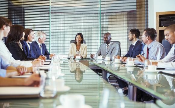 Business people having meeting in in conference room, smiling and discussing stock photo