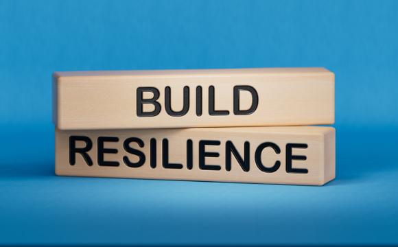 Wooden blocks with words Build resilience on blue background